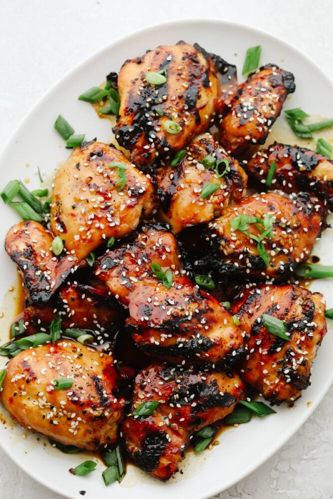 Grilled Honey Garlic Chicken on serving dish with green onion garnish.