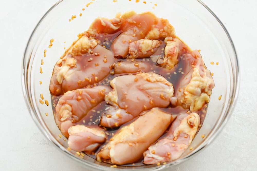 Chicken soaking in marinade.