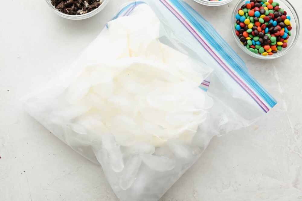 The ice cream mixture surrounded by the ice in a second bag. 