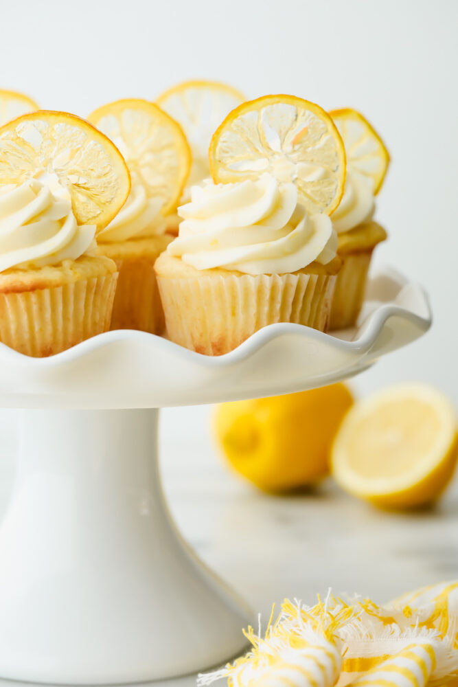 Lemon cupcakes with garnish on a serving platter.