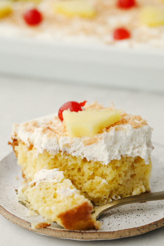 A slice of pina colada poke cake. 