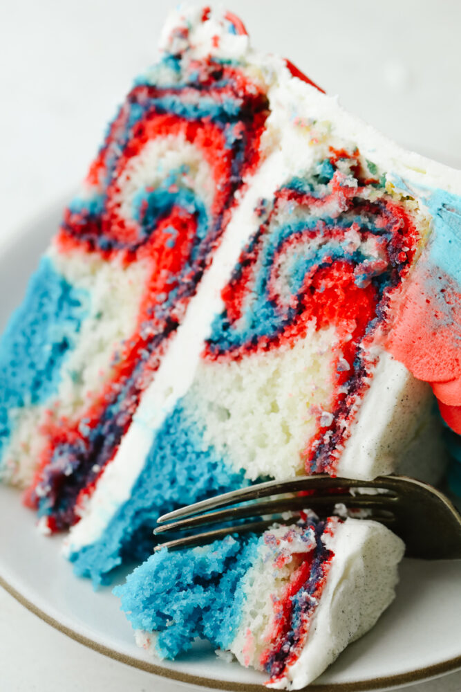 Cutting into the cake with a fork. 