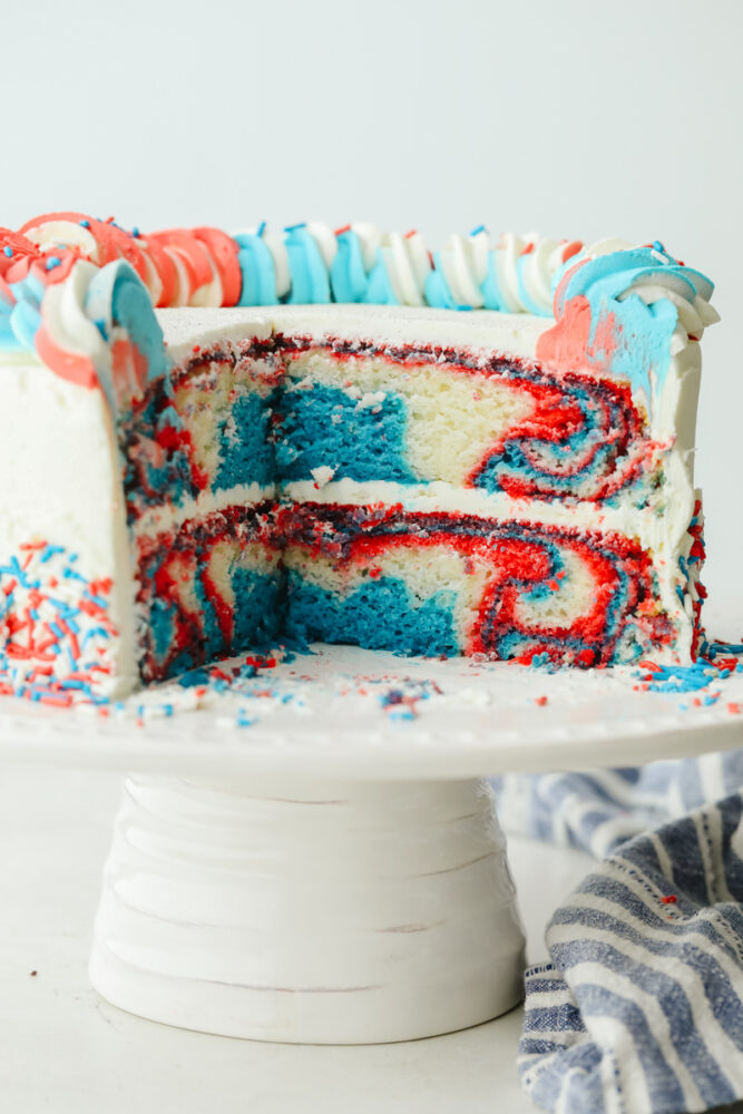 The red, white, and blue cake sliced so you can see the inside. 