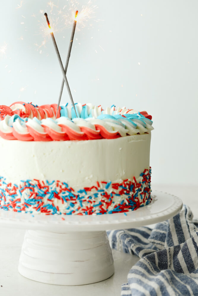 Decorated cake with sparklers on top. 