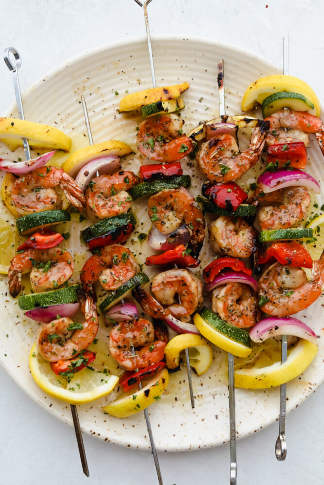 Grilled marinated shrimp on skewer with veggies.