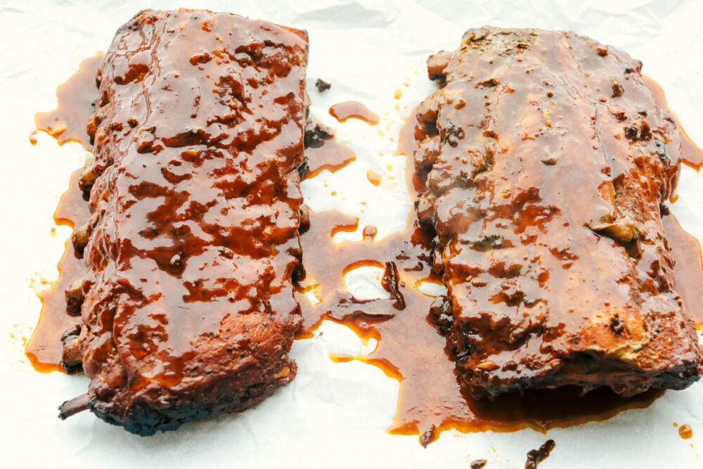 Adding extra sauce to the ribs before broiling. 