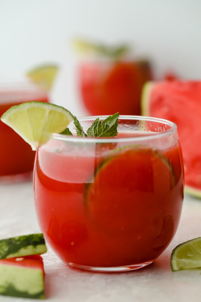 Watermelon agua fresca in cup with mint and lime garnish