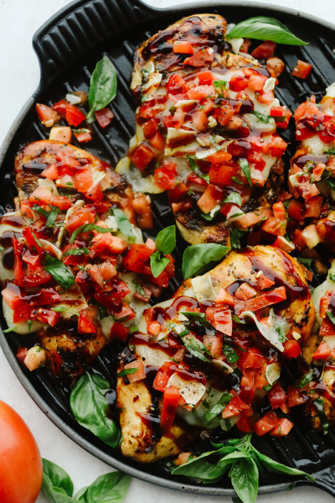 Pieces of Bruschetta Chicken on skillet.