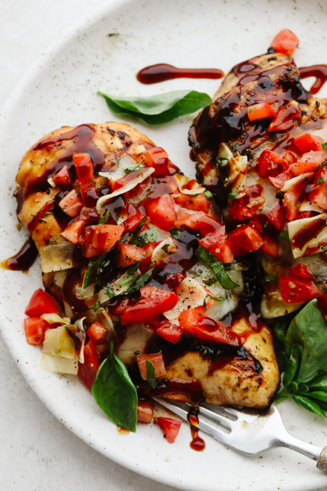 Bruschetta chicken on a white plate. 