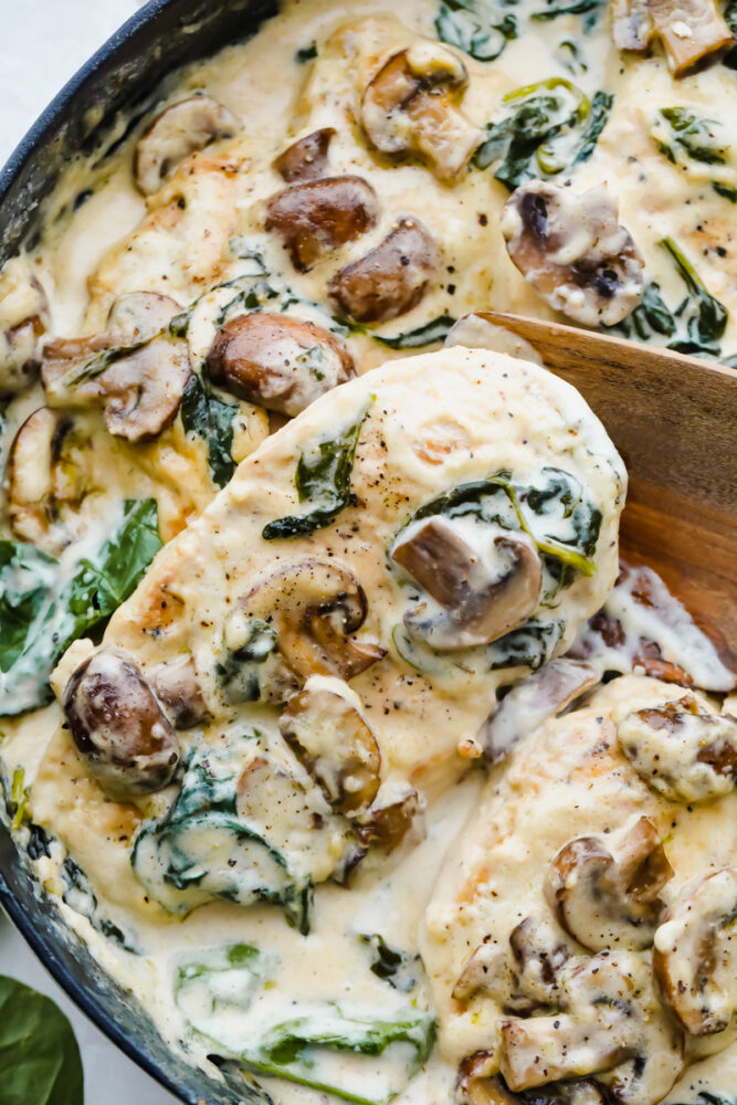 Creamy Parmesan Garlic Mushroom Chicken being cooked in a skillet. 