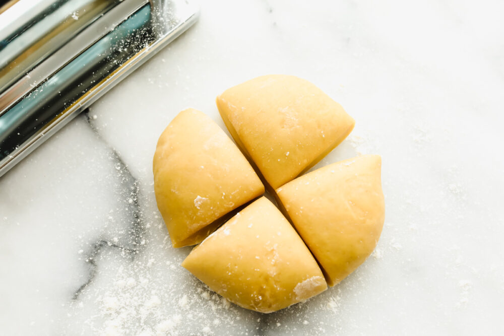 Cutting rested dough into quarters. 