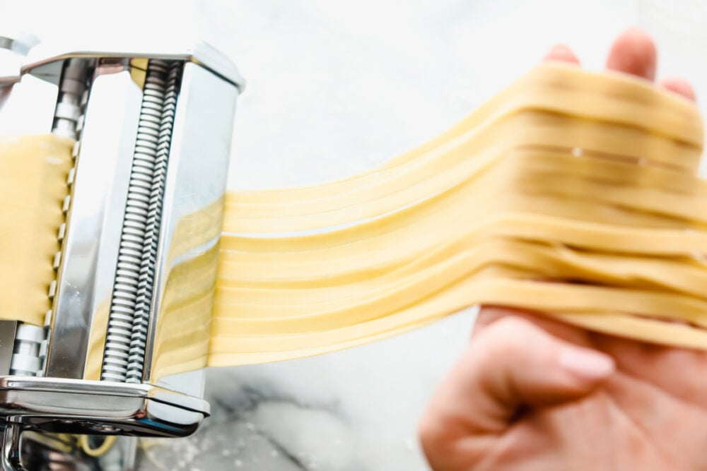 Cutting the dough into long strands for cooking. 