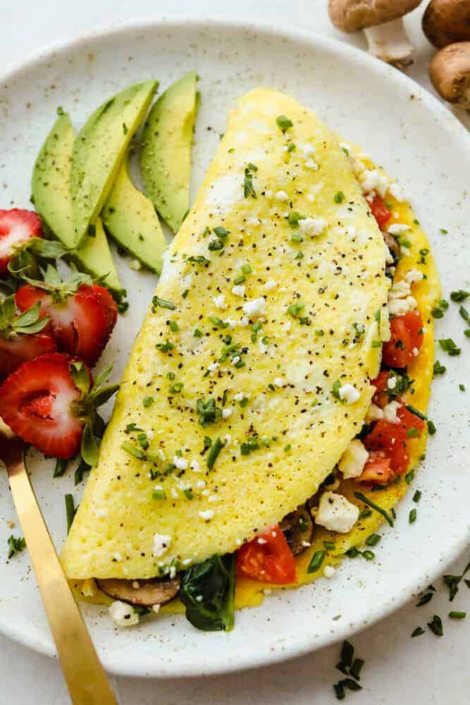 A cooked, finished omelet on a plate. 