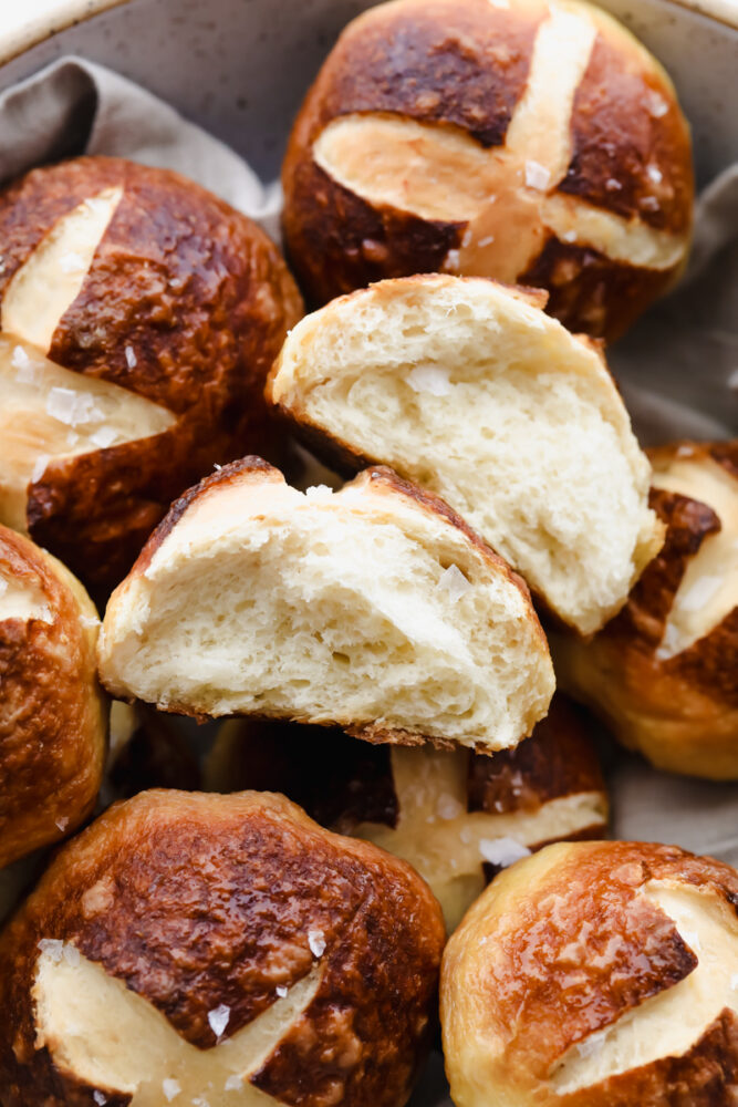 Close-up of Pretzel Roll being torn in half.