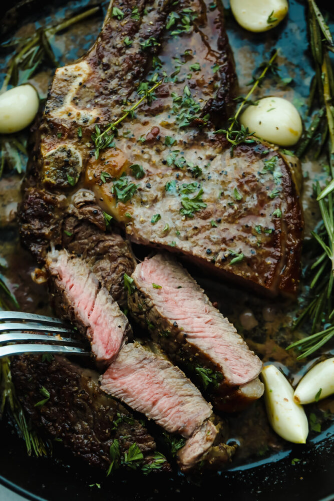 Cutting off slices of steak.