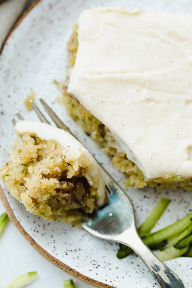 Using a fork to cut the zucchini bar. 