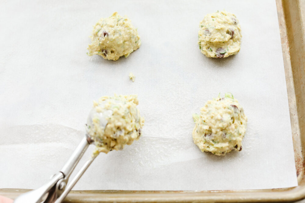 Scooping the dough onto parchment paper. 