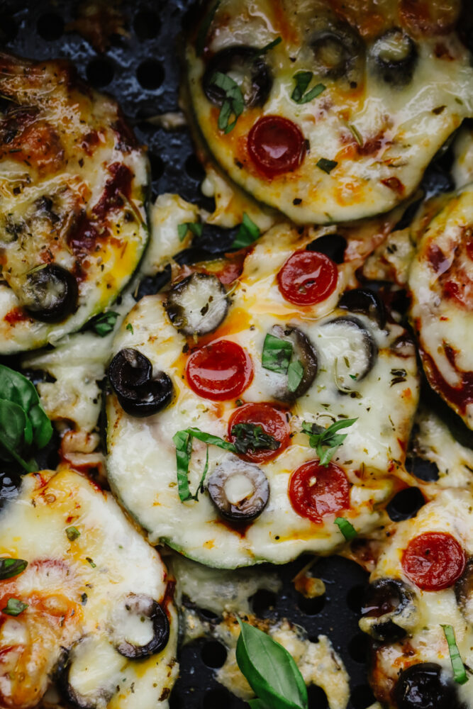 Savory zucchini bites garnished with fresh basil. 