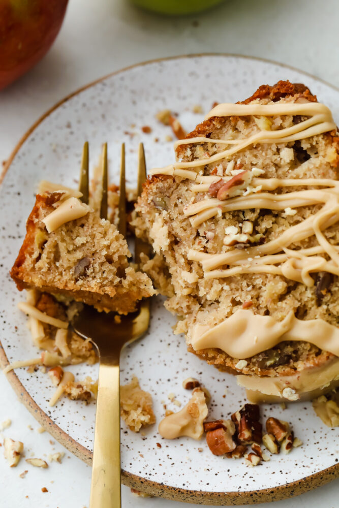 Cake on a plate being eaten with a fork. 