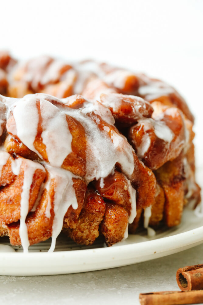 Finished cinnamon roll monkey bread on a white serving dish.