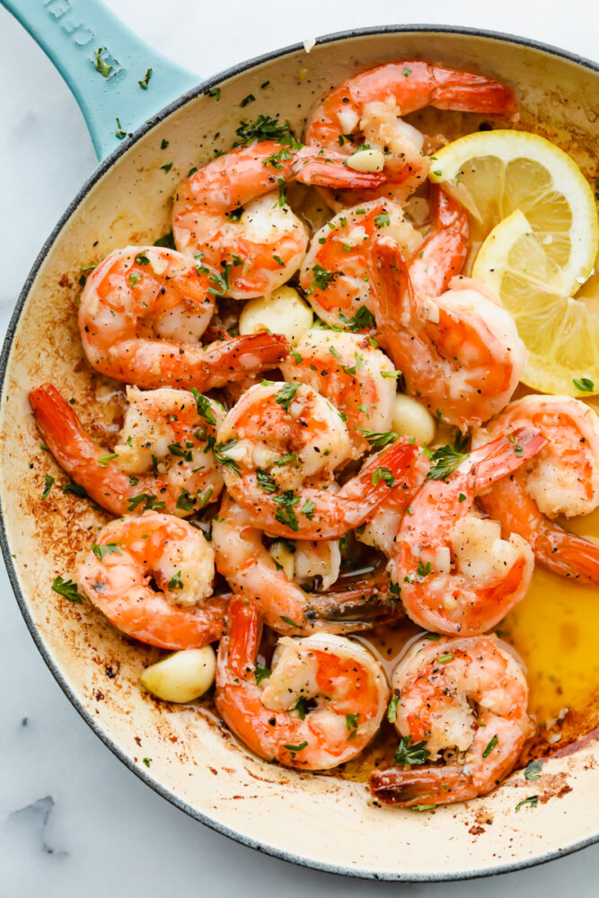 Cooked shrimp with garnish in a dish.