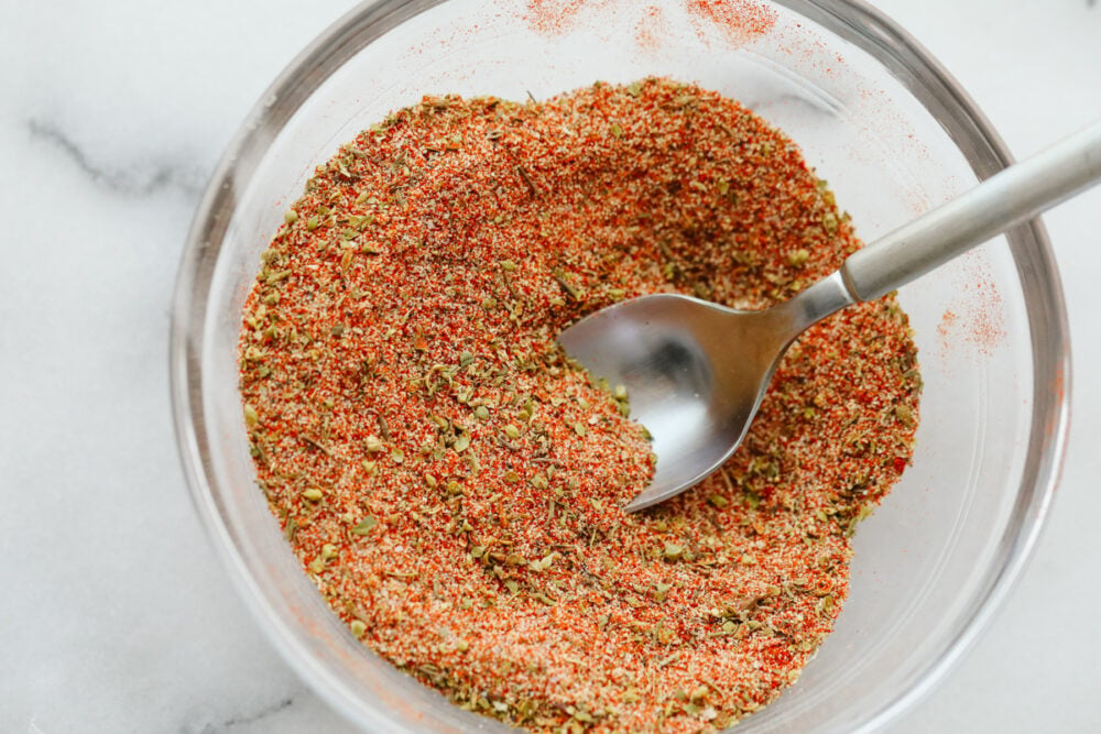 Cajon seasoning mixed in a bowl with a spoon. 