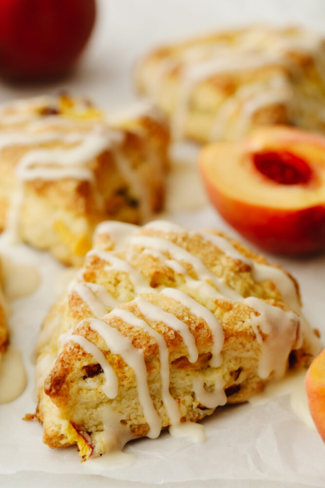 A glazed peach scone topped with crystal sugar. 