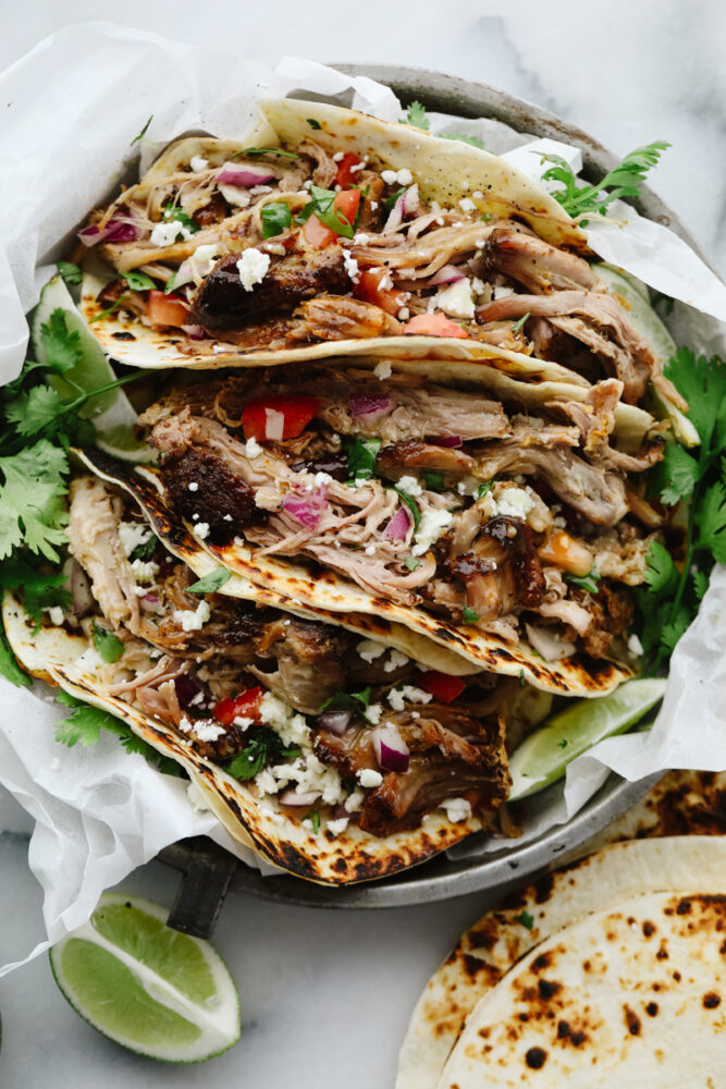 Pork carnita tacos in a dish. 