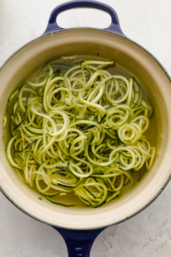 Boiling zucchini noodles.