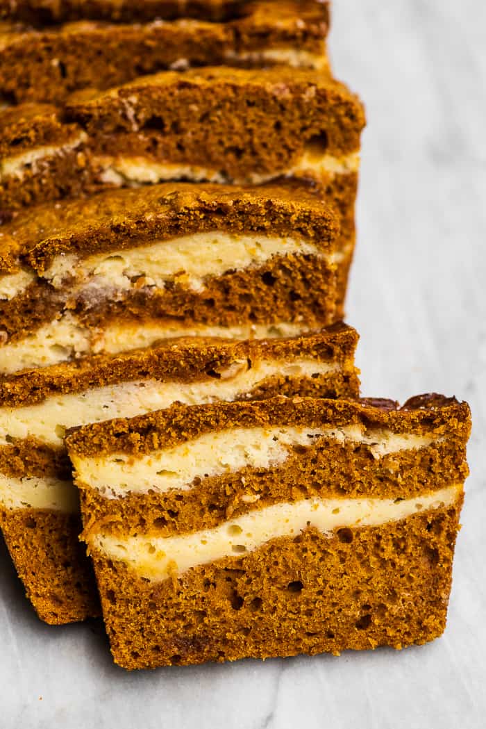 Slices of pumpkin bread with cream cheese swirls.