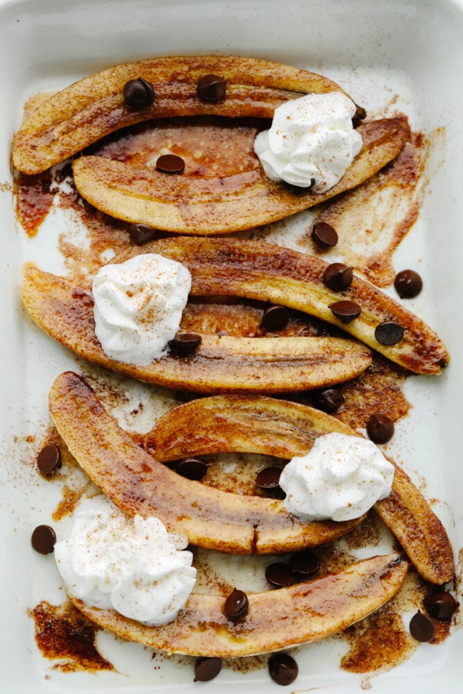 Sliced, baked bananas with toppings.