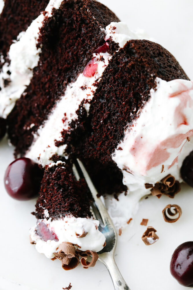 A slice of cake being cut with a fork. 