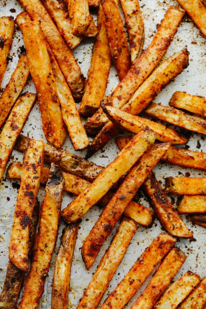 Cajun fries cooked on a baking sheet. 