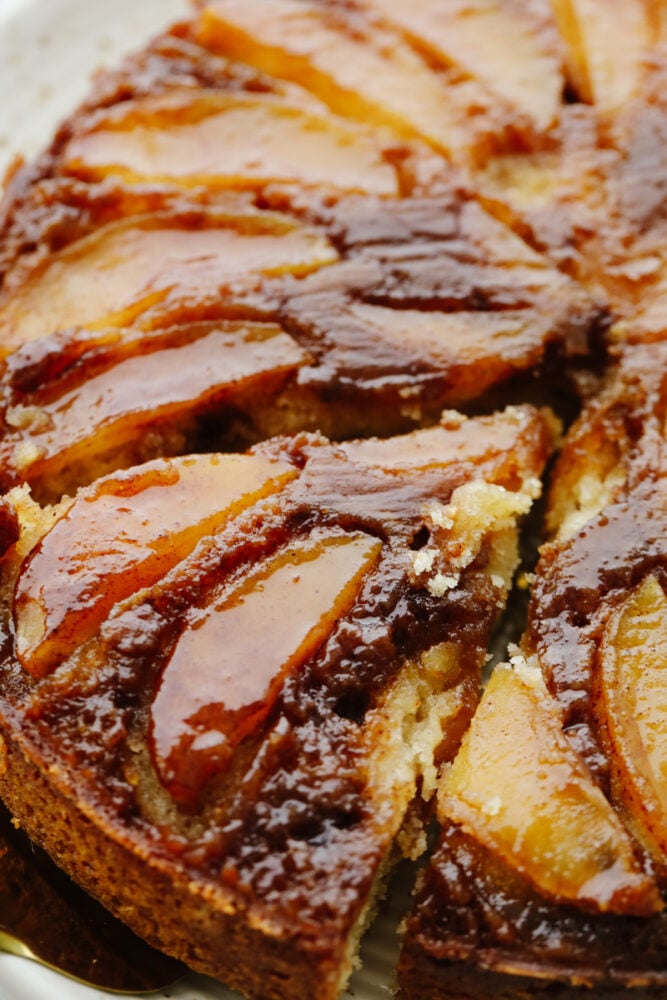 Close-up of a slice of apple cake with caramel glaze.