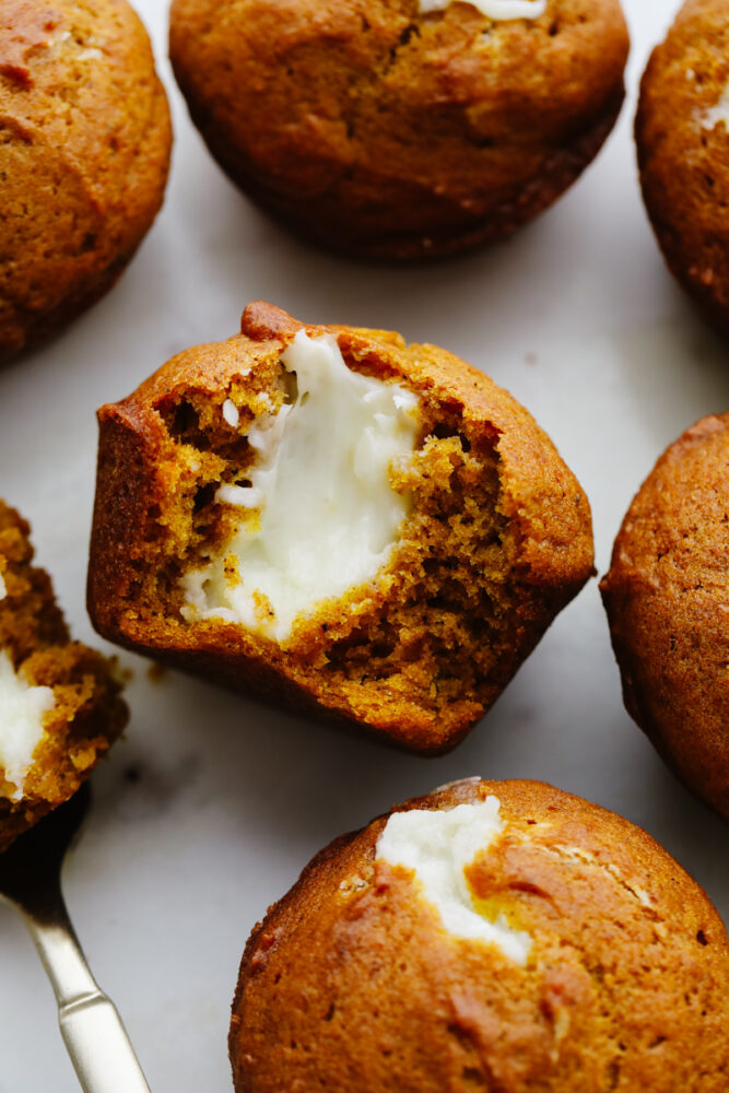 Pumpkin cream cheese muffins cut in half. 