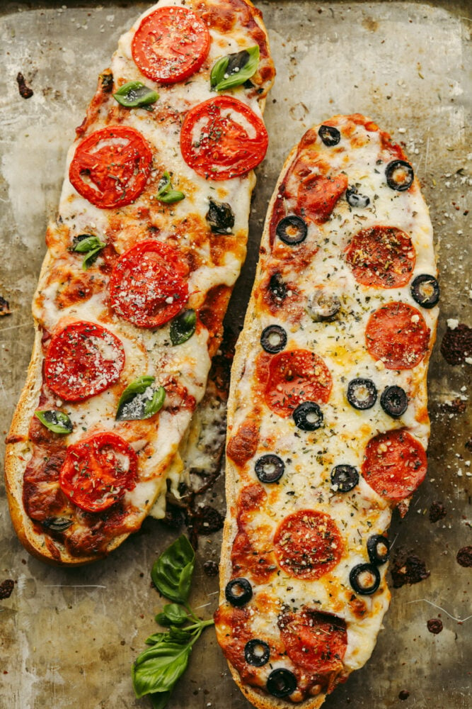 2 loaves of French bread pizza with different toppings. 