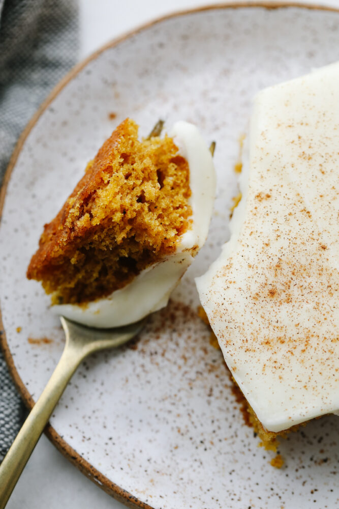 A fork cutting into a slice of pumpkin spice cake. 