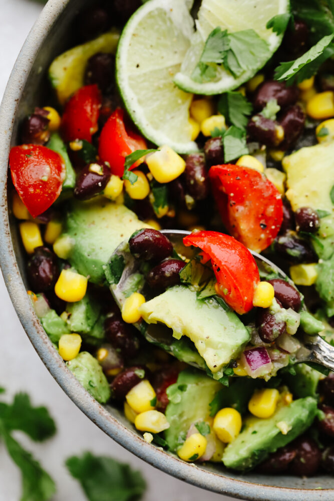 Black bean and corn salad on a spoon. 