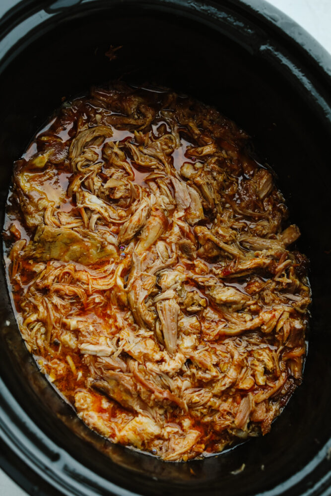 Sweet pulled pork being cooked in a slow cooker. 