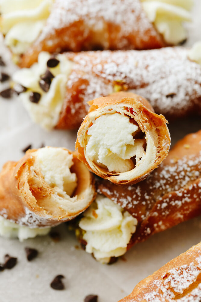 Closeup of a cannoli broken in half.