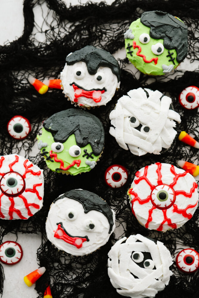 Various Halloween cupcakes served on black netting.