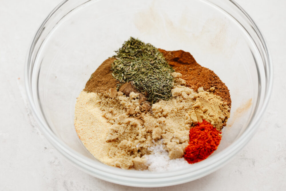 A bowl showing an array of spices ready to be mixed. 