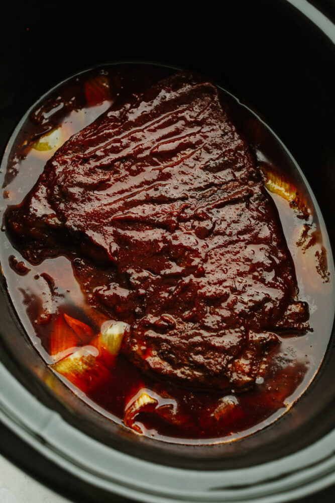 A beef brisket in a slow cooker.