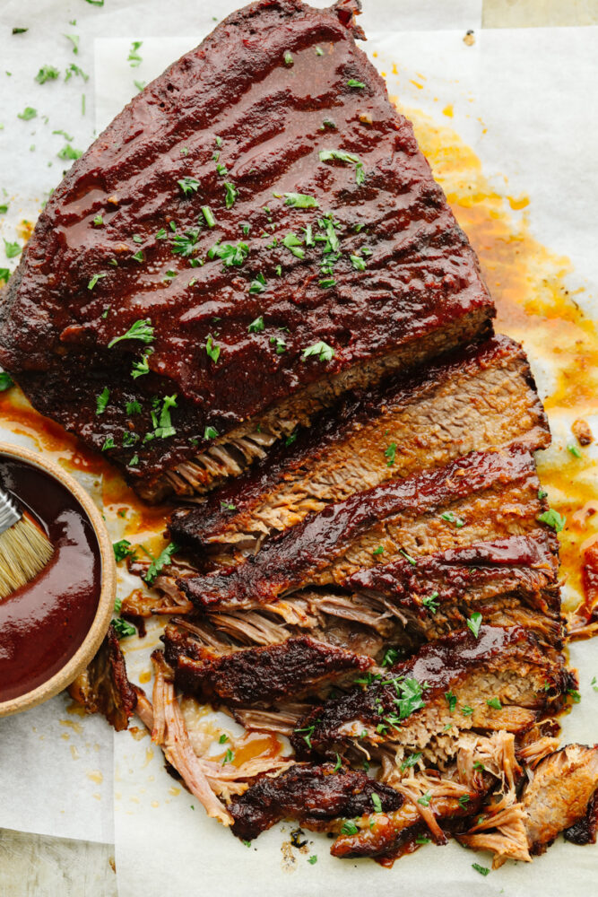 A beef brisket sliced on a platter. 