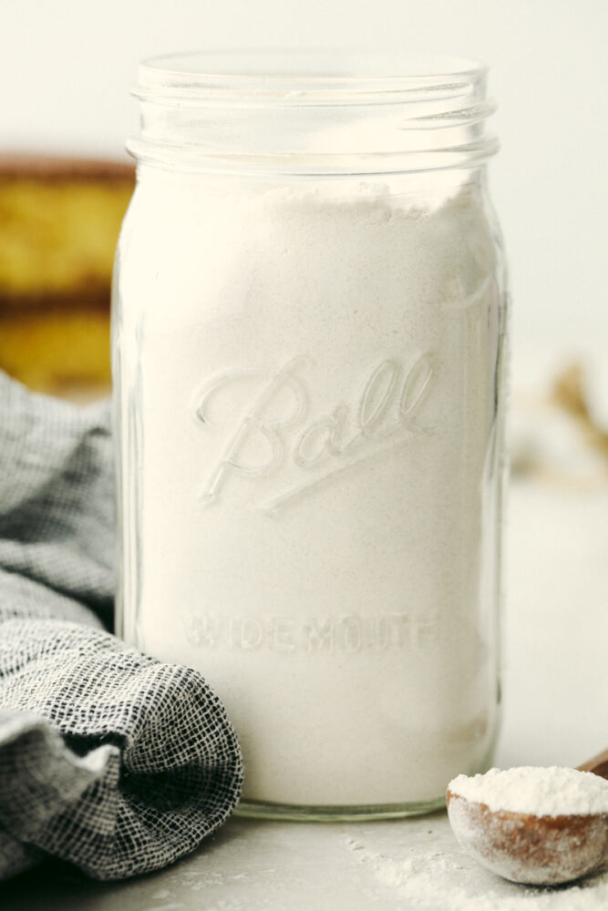 Jar full of dry cake mix ingredients. 