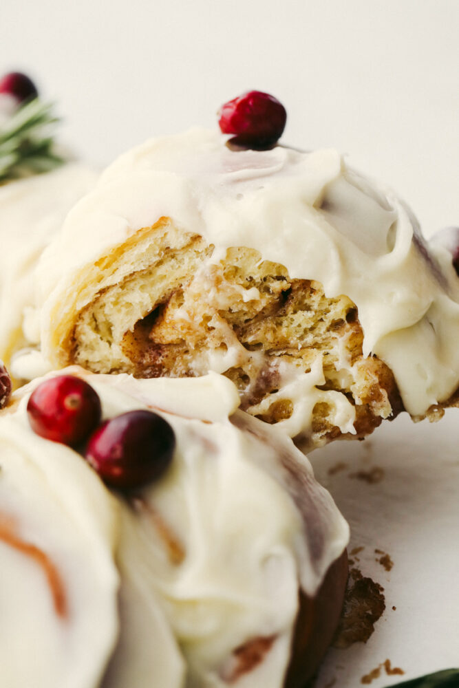 A cinnamon roll wreath being sliced. 