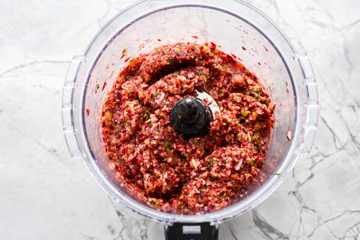 Overhead shot of ingredients mixed in a food processor. 