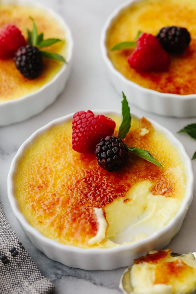 Creme brûlée topped with fruit. 