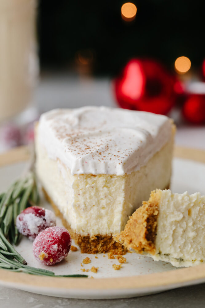 A slice of cheesecake with a fork cutting into it. 