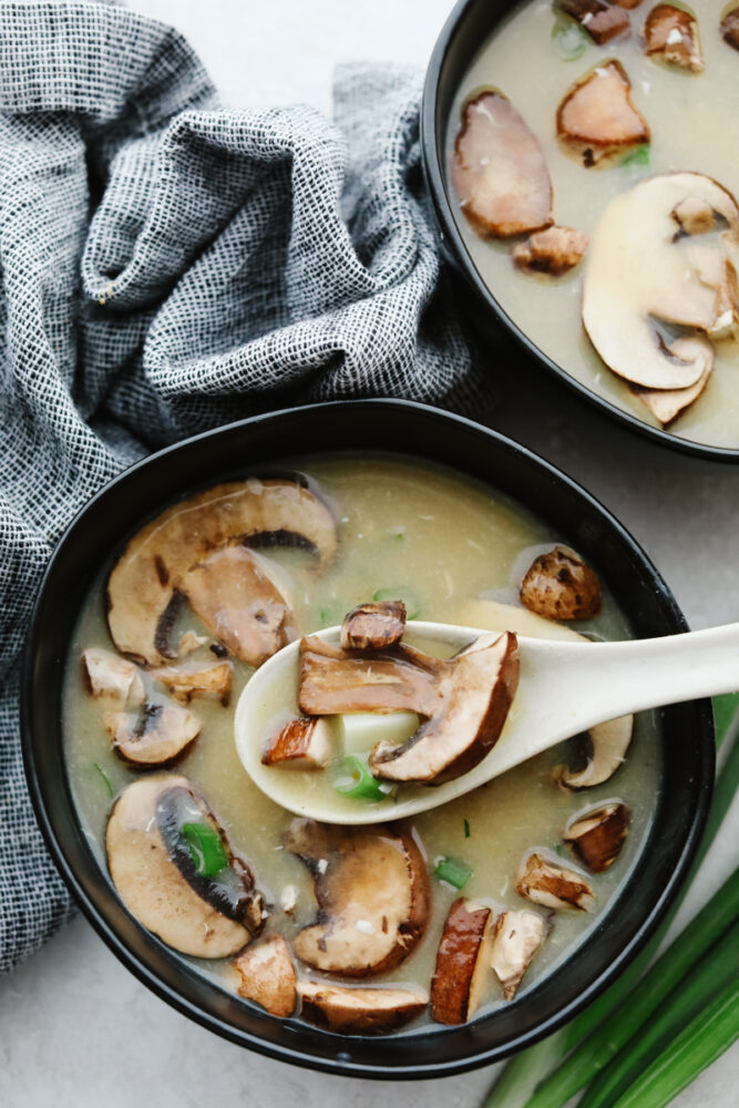 A bowl of hot and sour soup with a serving spoon, ready to eat! 